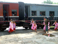 Nuns running for a train, Myanmar