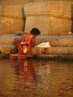 Man performing puja at sunrise in the Ganges, Varanasi