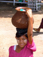 Girl selling water from her head, Myanmar