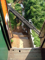 Looking out of an open train door, Myanmar