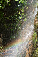 Rainbow in spray from small waterfall
