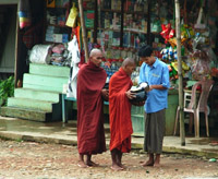 Buddhist monks recieving alms in Kyaiktiyo, Myanmar